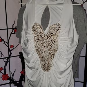 White sleeveless top with gold accents